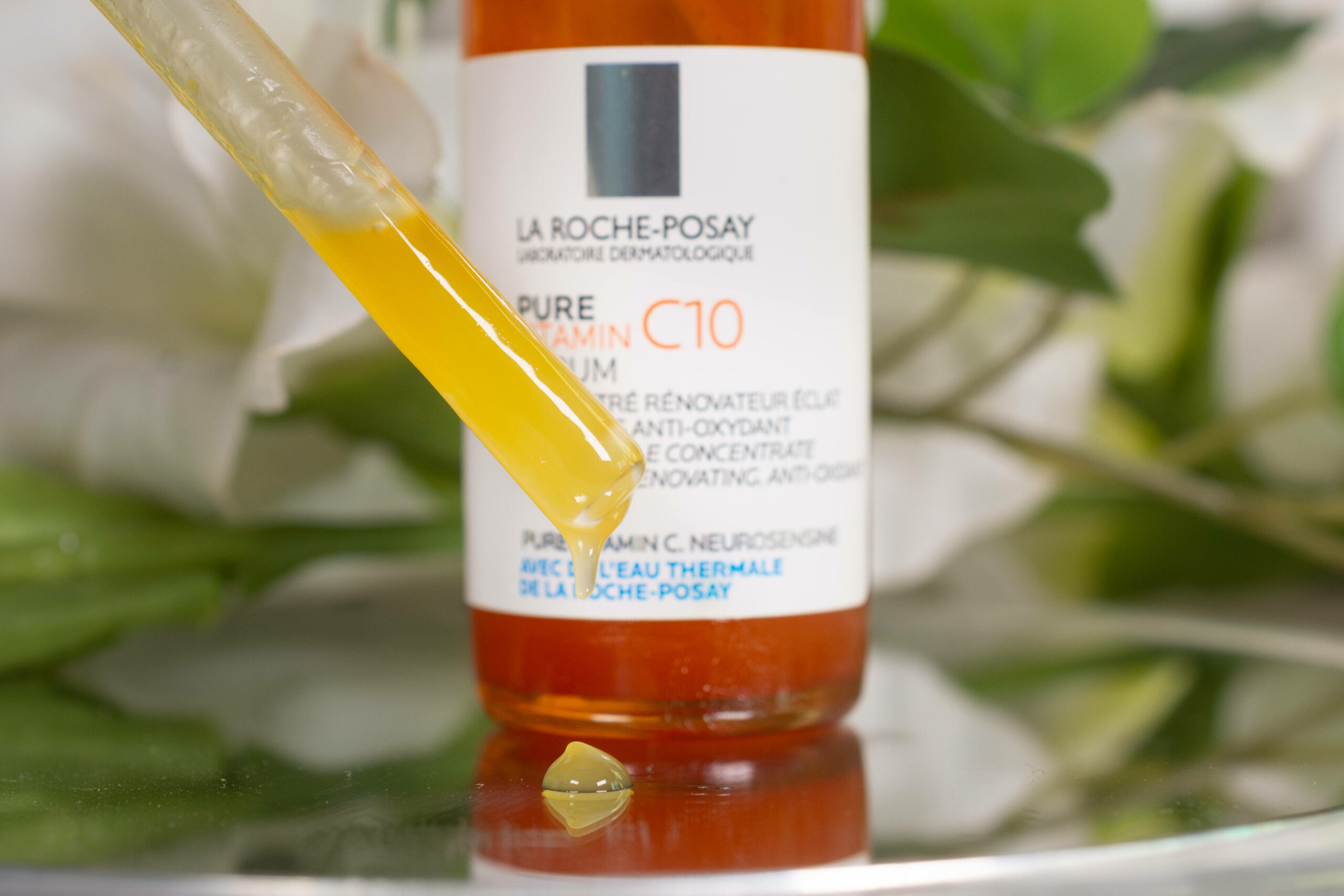 Light orange liquid in a dropper pipette in front of a bottle of La Roche Posay Pure Vitamin C10 Serum