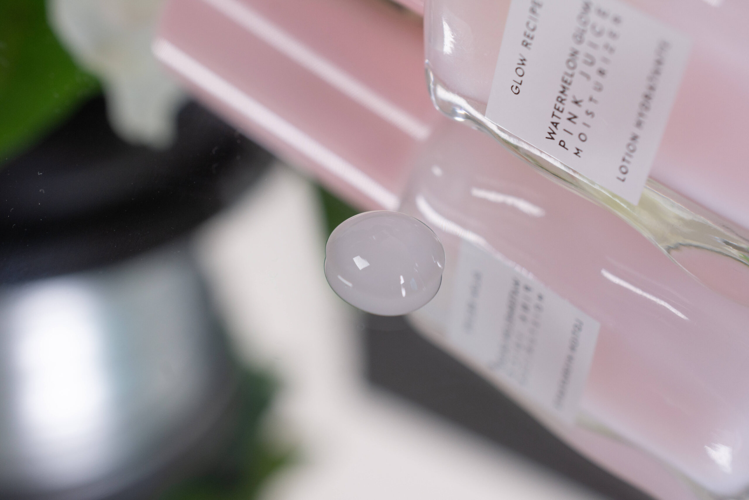 Close up of the Glow Recipe Watermelon Glow Pink Juice Moisturizer, a powder pink slightly shimmery lotion