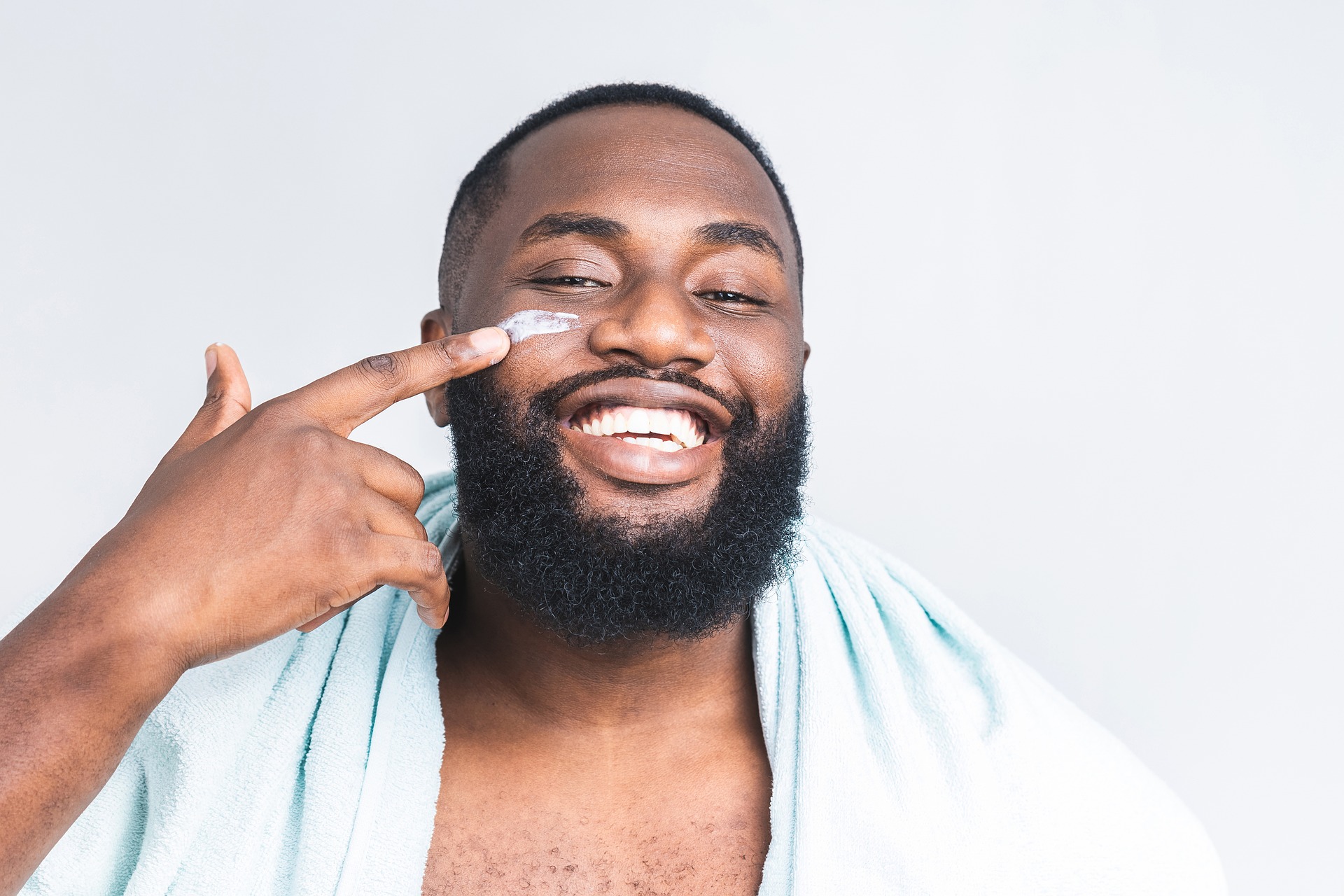 Man applying cream to his face