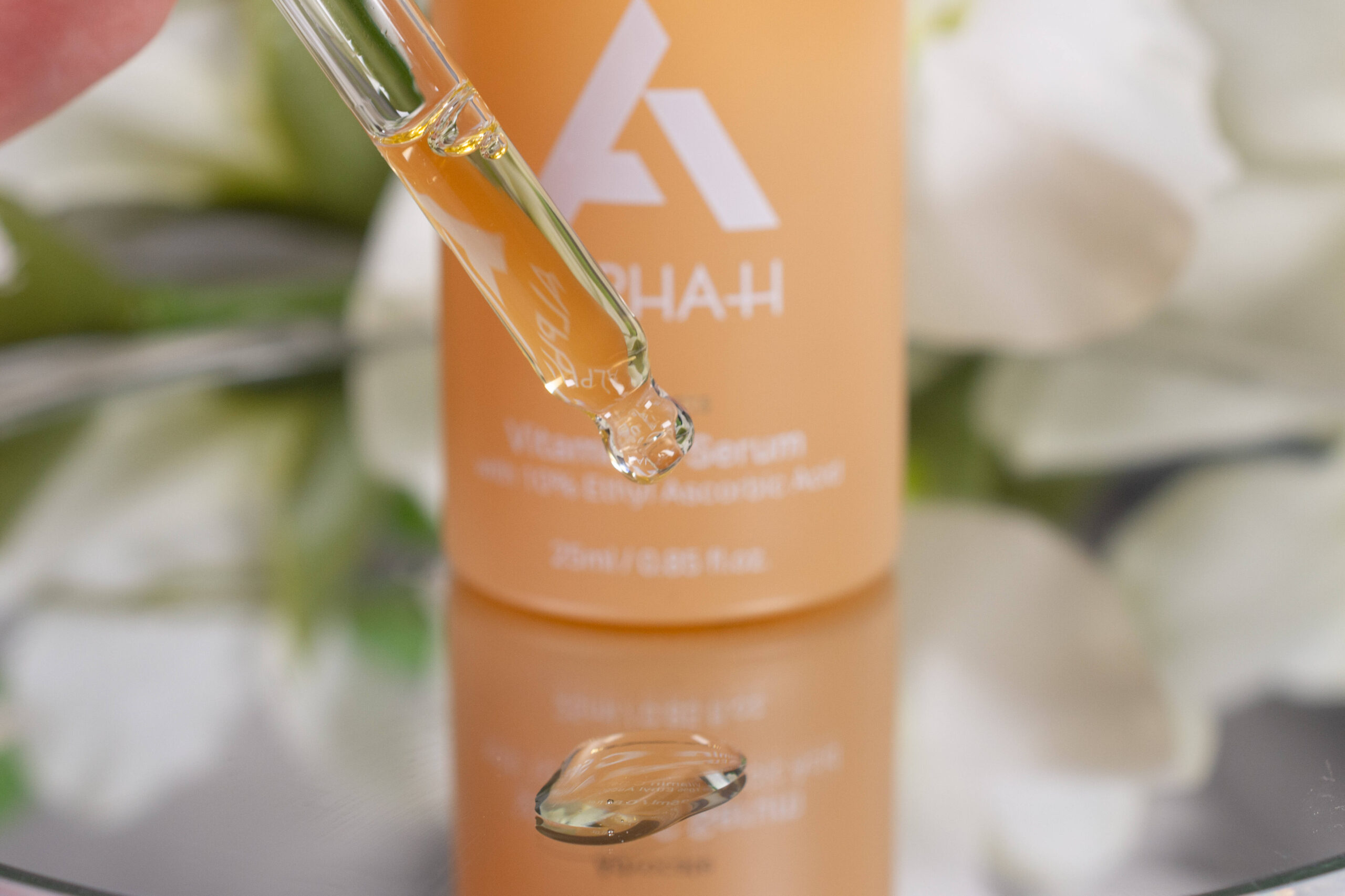 Close up of the Alpha-H Advocate Vitamin C Serum, which looks slightly yellow and slightly oily