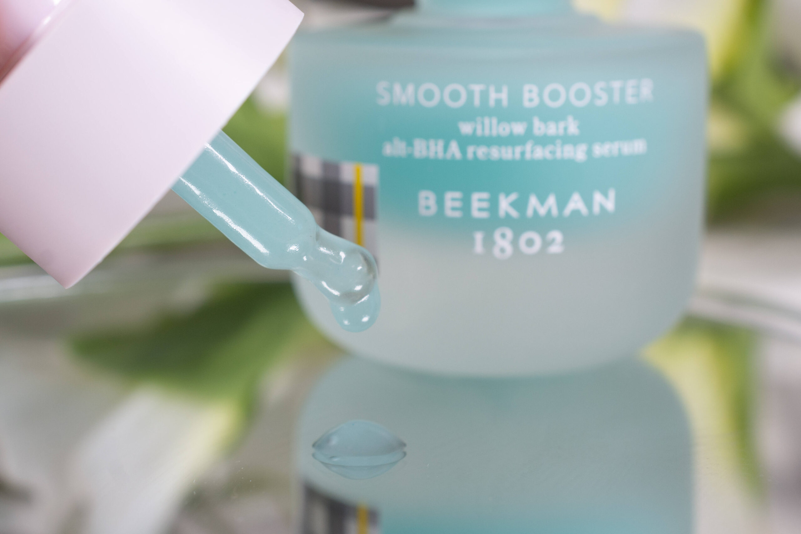 Close up of the Beekman 1802 Smooth Booster, a blue, slightly gooey liquid.