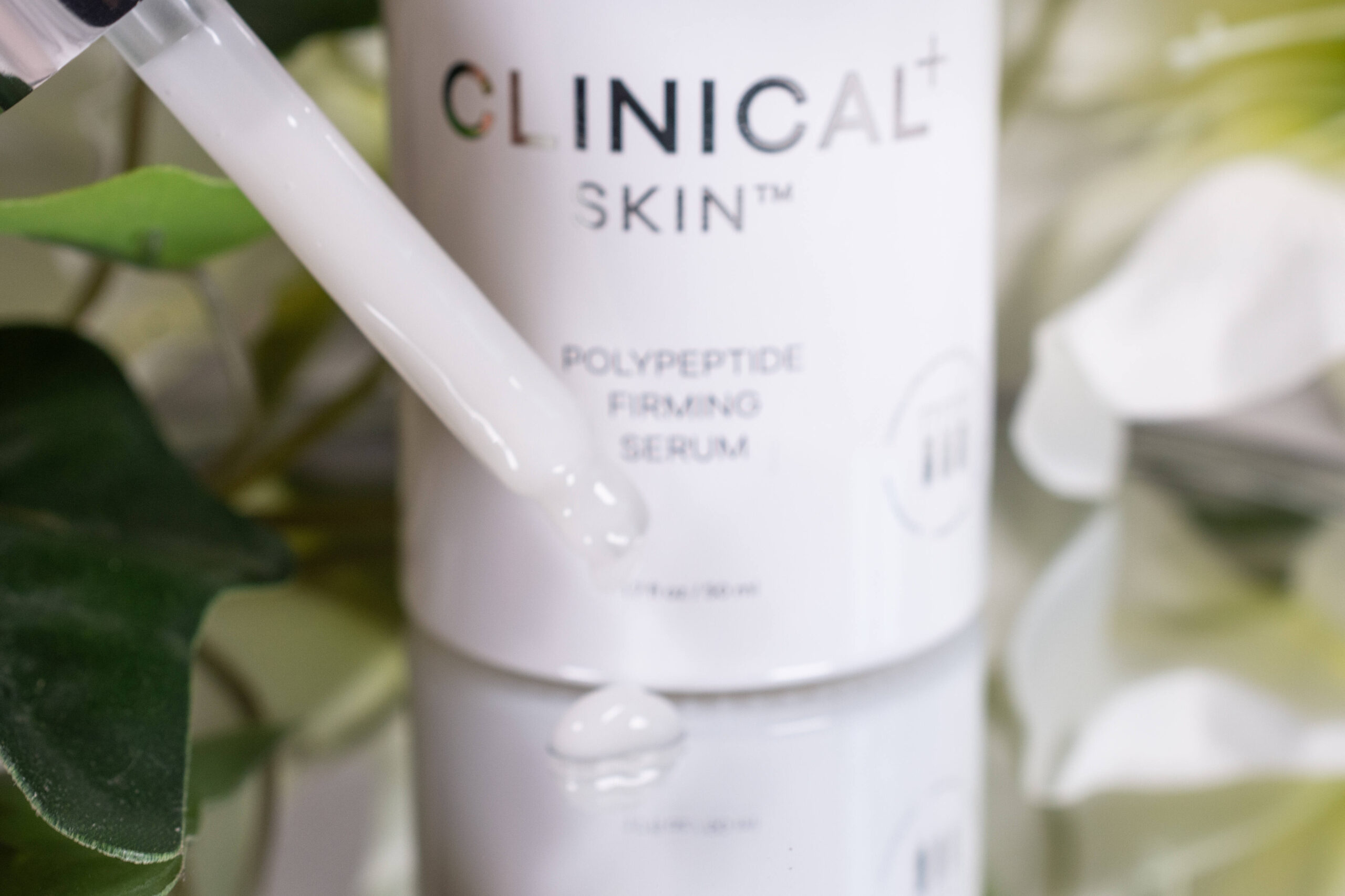 Close up of the Clinical Skin Polypeptide Firming Serum, a milky white lotion