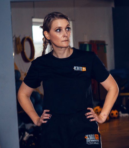 blonde woman with boxing braids wearing workout gear.