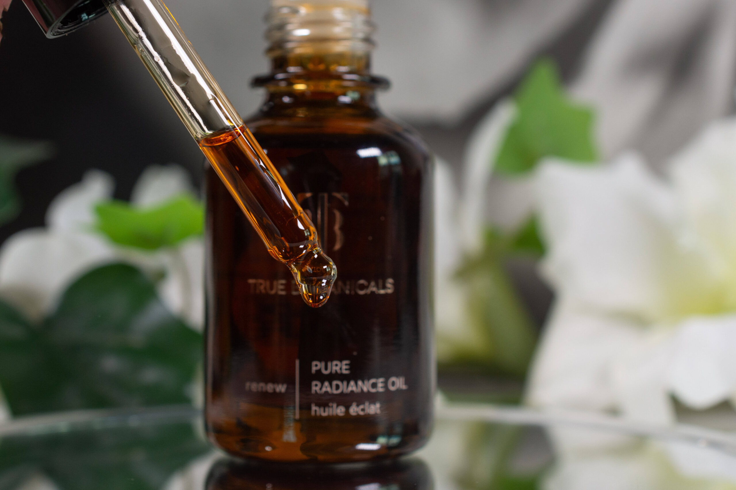 Close up of the True Botanicals Pure Radiance Oil, which has a lovely reddish brown color