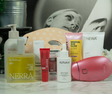 A collection of products from skincare devices over skincare to makeup standing in front of a dark background