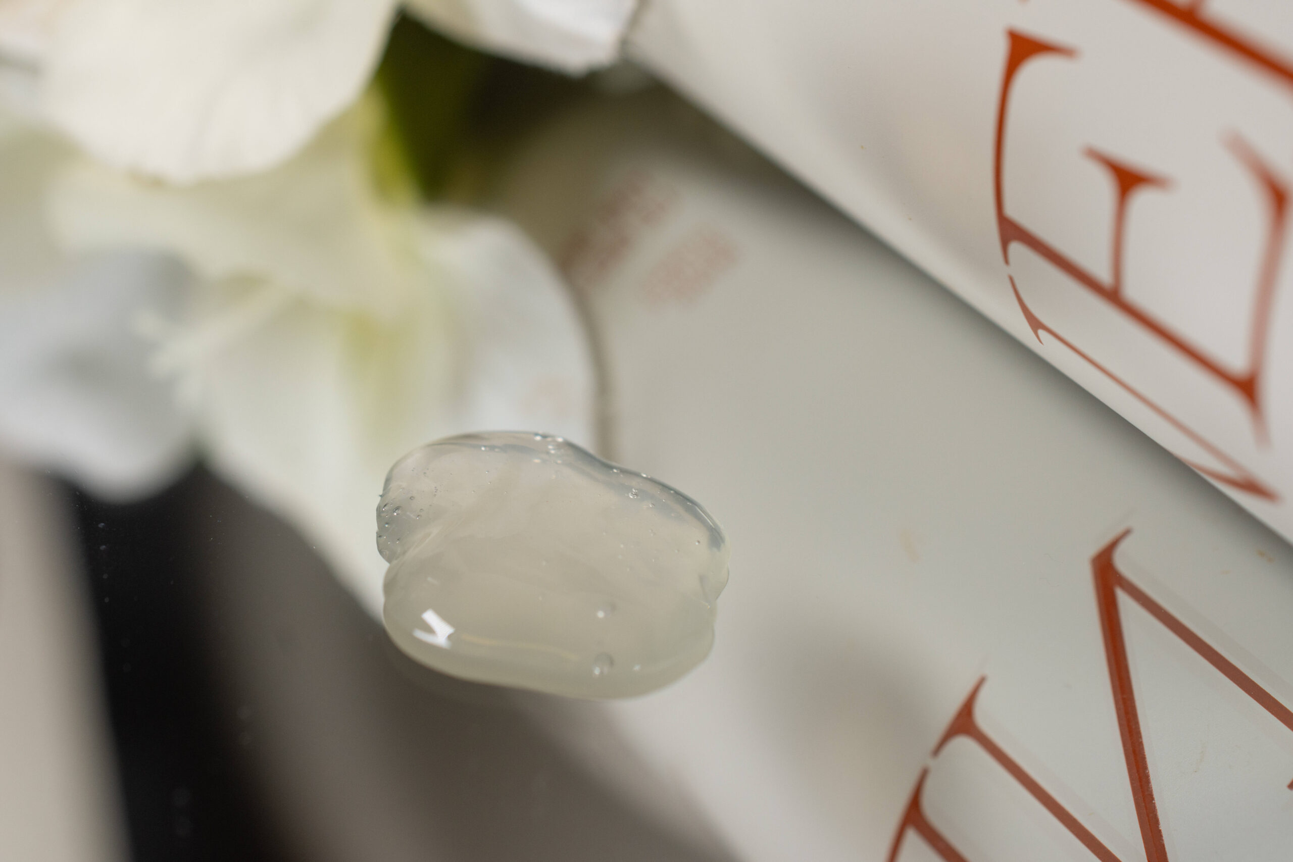 A close up of the Nerra Body Wash on a mirrored surface